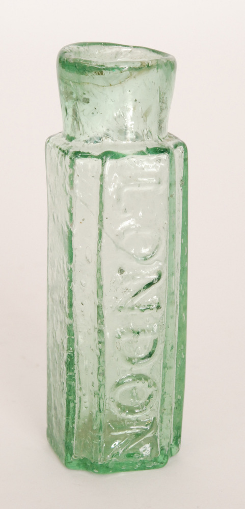 An early 19th Century blow moulded glass mustard bottle of shouldered square section with canted