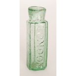 An early 19th Century blow moulded glass mustard bottle of shouldered square section with canted