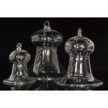 A set of three graduated early 19th Century clear crystal smoke bells with upper hanging loops and