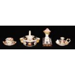 Three pieces of 19th Century Derby porcelain comprising a taper stick, table salt and an inkwell,