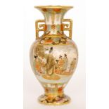 A late 19th Century Japanese Meiji period twin handled footed vase decorated with two gilt and