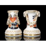 A pair of early 20th Century Meissen spill vases each moulded with ram heads with a foliate garland