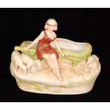 A Royal Dux Bohemia planter modelled as a scantily clad lady sat on a bench with sheep by her side,