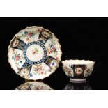 An 18th Century Worcester fluted teabowl and saucer decorated with alternate floral prays between