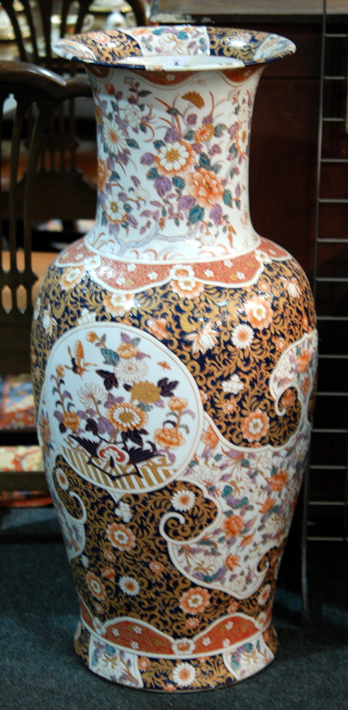 A large later 20th Century Chinese floor vase decorated with floral panels against a patterned