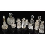 A collection of Victorian and later silver mounted cut glass scent bottles of various shapes and