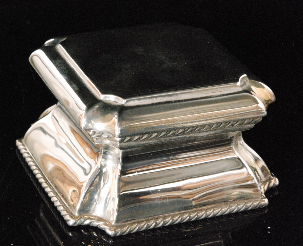 A hallmarked silver square shaped ink well with rope twist detail to foot below plain body and