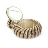 A Victorian hallmarked silver circular scent bottle and compact combination of spiral fluted from,