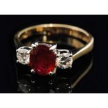 A hallmarked 18ct ruby and diamond three stone ring,