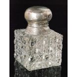 A hallmarked silver and clear glass ink well of square section with hobnail cut base below plain