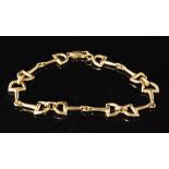 Amended description - An 18ct link bracelet designed as five pairs of stirrup shaped links with