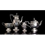 A hallmarked silver four piece tea service composed of teapot, twin handled sugar bowl,