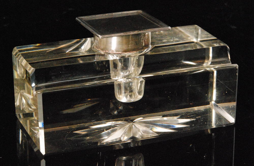 A hallmarked silver and clear glass ink well the rectangular glass base with a single pen rest