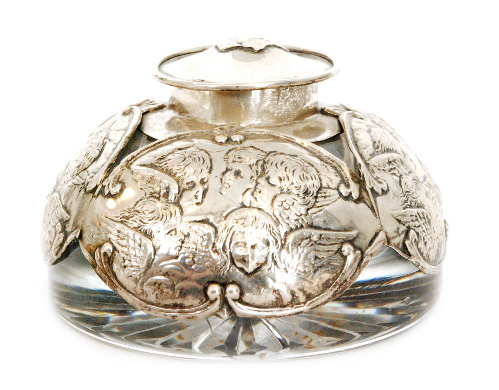 An Edwardian hallmarked silver and clear cut glass domed shaped ink well decorated with four panels