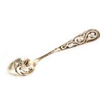 A hallmarked silver teaspoon with Iona and an embossed dove to the bowl below stylised floral