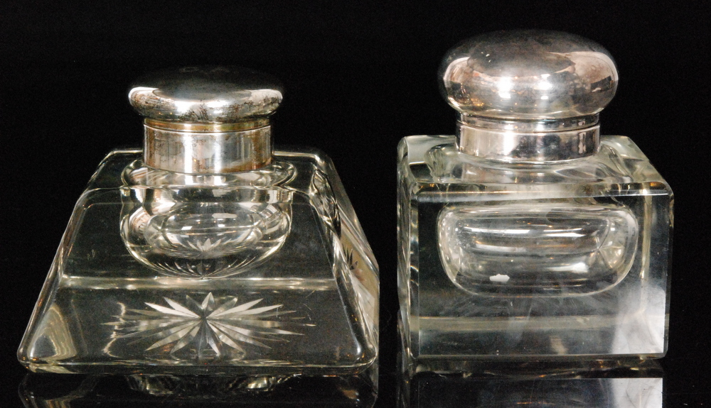 A hallmarked silver and clear cut glass ink well,