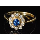 A hallmarked 18ct sapphire and diamond cluster ring,