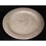 A 20th Century white metal circular salver with Persian style engraved decoration to whole,