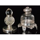 A Sterling silver and clear cut glass ink well raised on a pieced stand,