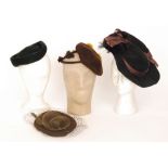 Two 1940s lady's vintage hats, the first in black felt with a brown ribbon trim and black feathers,