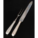 A pair of hallmarked silver handled carvers each with reeded detail to handles, Sheffield 1936. (2).