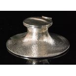 An early 20th Century hallmarked silver capstan ink well with hammered decoration to whole and
