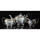 A George V hallmarked silver three piece tea service composed of teapot, sugar bowl and cream jug,