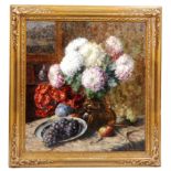 PAUL CREMERS (1923-1987) - A still life with chrysanthemums in a vase and fruit on a table top,