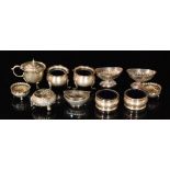 Ten hallmarked silver early 20th Century open salts with a similar mustard pot, total weight 14oz,