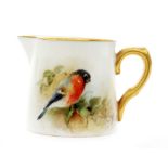 A miniature Royal Worcester cream jug decorated with a hand painted bullfinch,