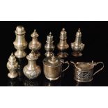 Seven hallmarked silver early 20th Century pepper pots with two similar mustard pots,
