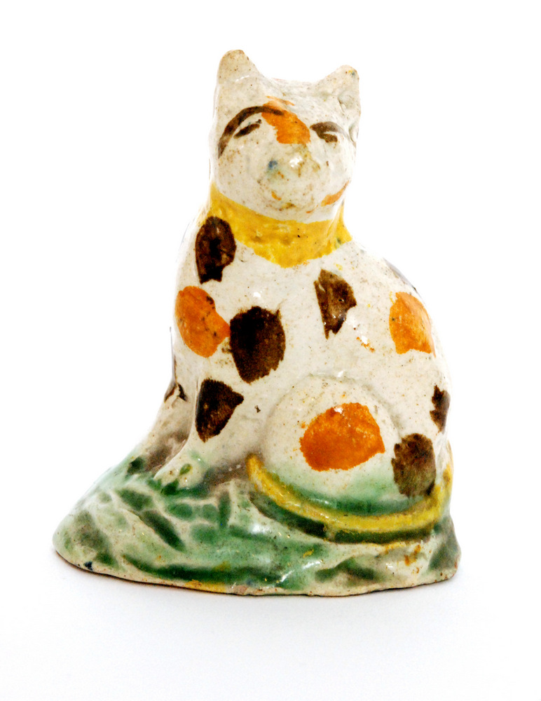 A late 18th to early 19th Century Staffordshire Pratt ware type model of a cat,