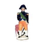 A 19th Century Staffordshire open base figure of Nelson stood dressed in a blue and orange naval