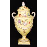 A late 19th to early 20th Century twin handled pedestal vase and cover decorated with sprays of