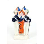 A 19th Century Staffordshire figure modelled as Prince Albert and Napoleon stood in military