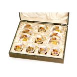 A cased set of six Royal Worcester coffee cups and saucers panel decorated by Harry Stinton with