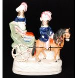 A 19th Century Staffordshire figure modelled as the Prince of Wales and the Princess Royal riding