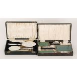 Two Art Deco enamelled back plated dressing table sets in fitted cases (2)