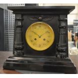 A 19th Century Egyptian revival black slate mantle clock with eight day striking movement,