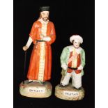 Two 19th Century Staffordshire portrait figures, the first of Shylock stood in an orange robe,