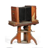 A Victorian brass mounted portrait camera with adjustable tripod stand,