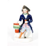 A 19th Century Staffordshire model of a Greenwich Hospital pensioner with peg leg and seated beside