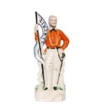 A 19th Century Staffordshire portrait figure of Garibaldi stood with his hand resting on a sword