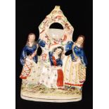 A 19th Century Staffordshire pocket watch holder flatback modelled as the Three Graces stood before