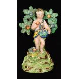 A 19th Century Walton modelled of a cherub stood before a flowering bocage holding a basket of