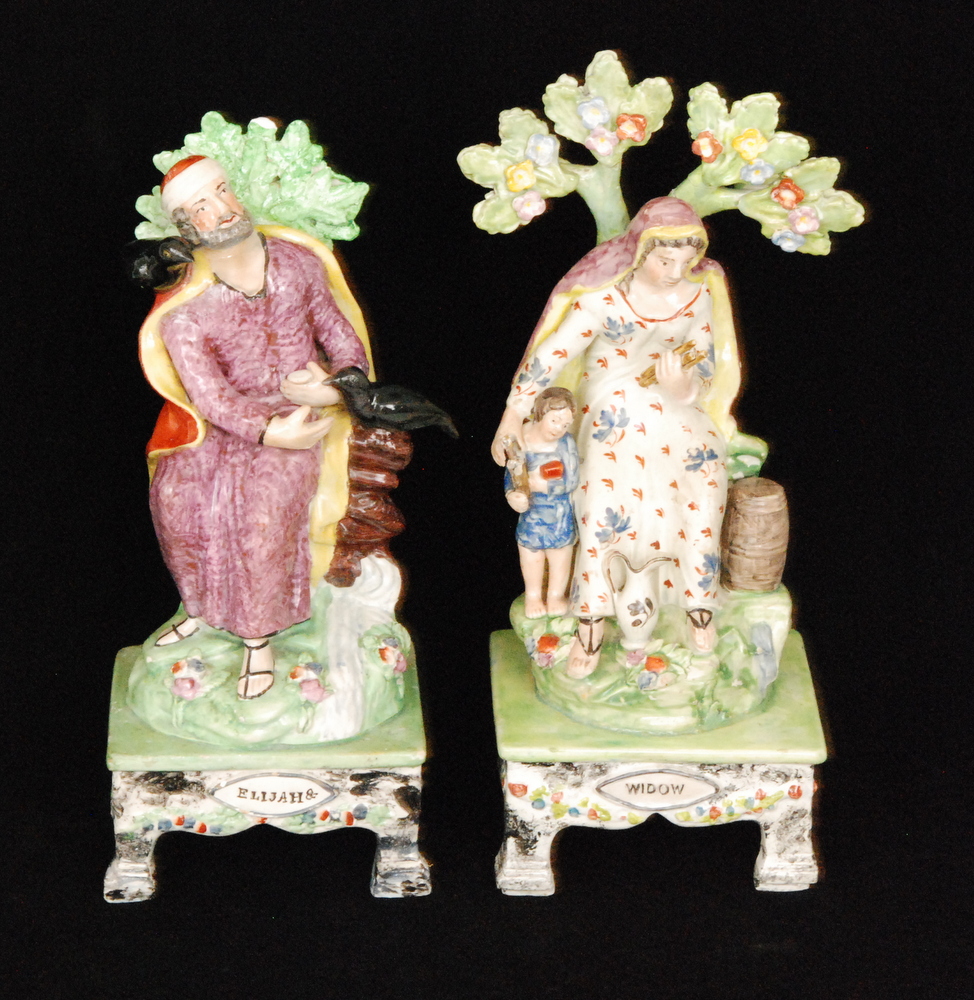 An early 19th Century Staffordshire figural pair modelled as Elijah and the Widow,