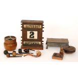 A 1930s oak adjustable desk/ date calendar together with four novelty ashtrays and a collection of