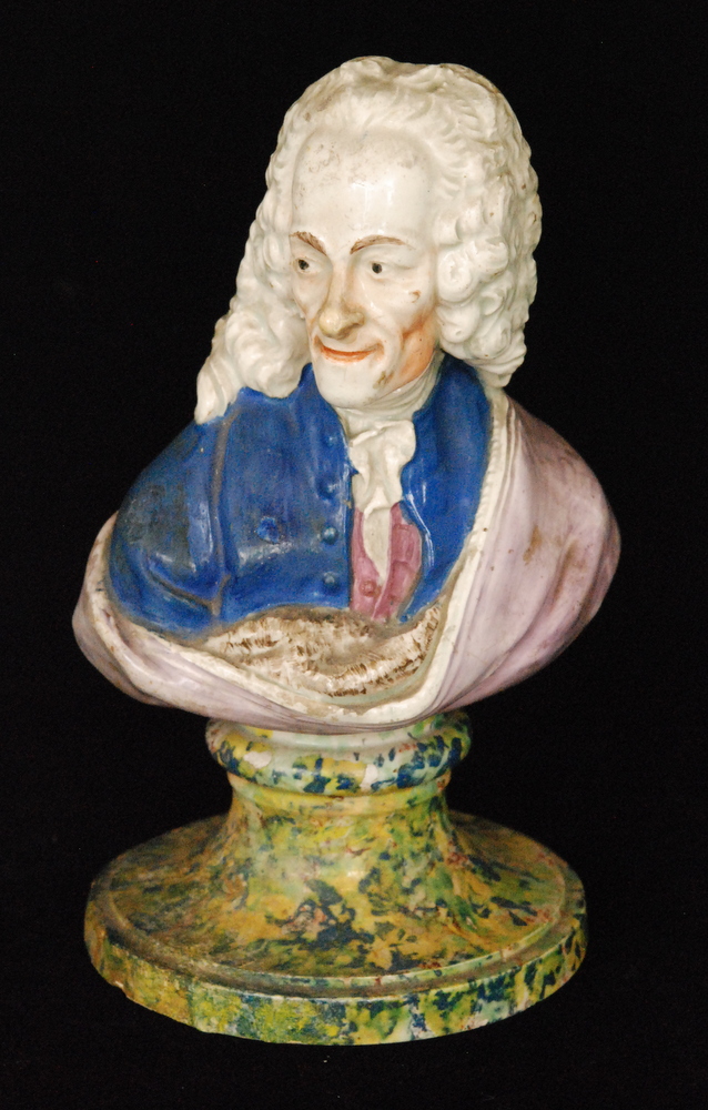 An early 19th Century Staffordshire pearl ware bust of Voltaire raised to a faux marble pedestal