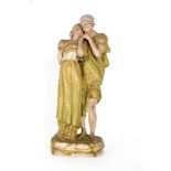 A Royal Dux Bohemia figural group modelled as two young lovers dressed in classical dress stood on