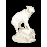 An early 20th Century Alexander von Wahl blanc de chine model of a bear on a rocky base with green
